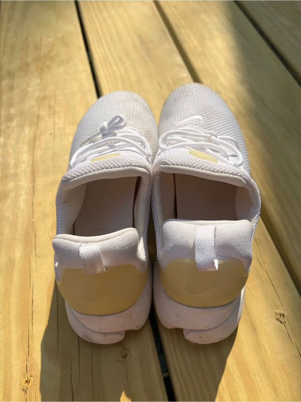 Nike Women’s White Mesh Sneakers with Cream Accents.